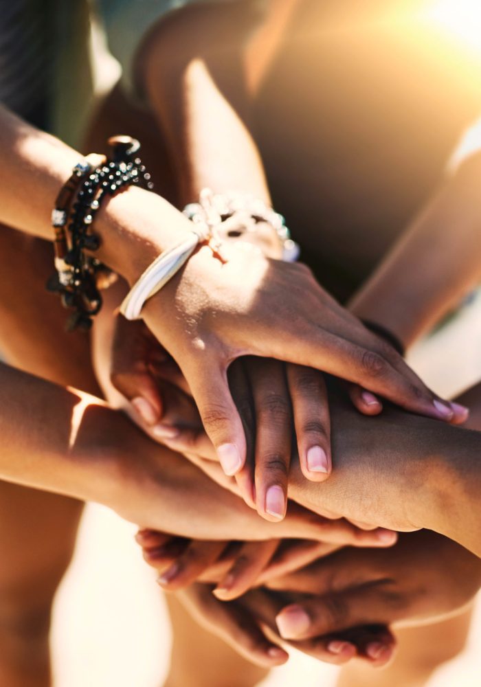 Cropped shot of a group of unrecognizable people piling their hands